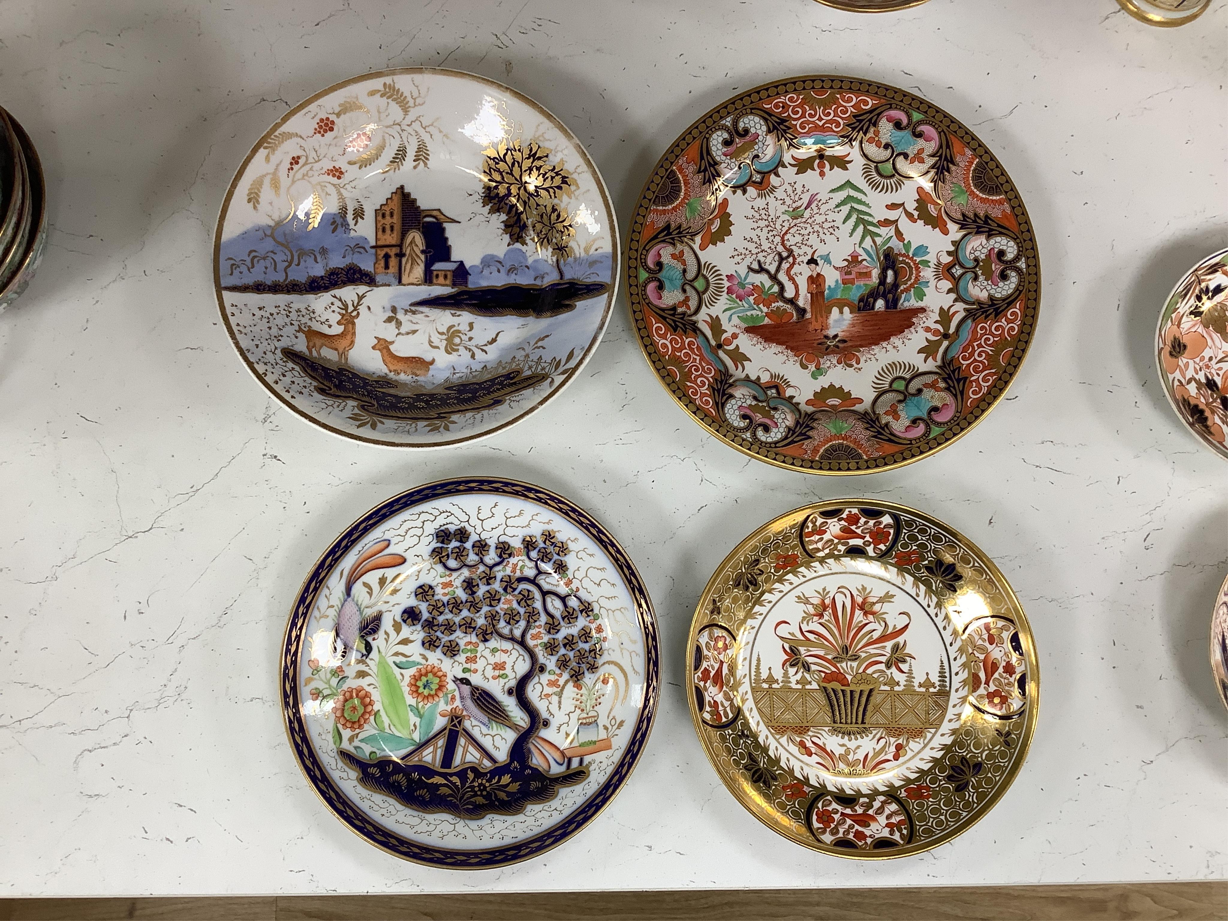 Sixteen mixed items of 1800-1820 English porcelain tableware, to include: three sucriers and covers, an oval ornately decorated dish, four saucer dishes, a candle holder, three spill vases and four saucers